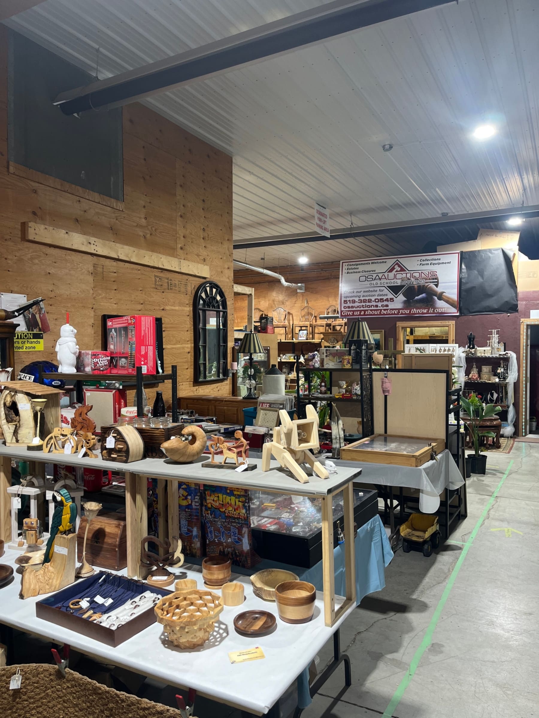 Inside the OSA Auctions building, with vendor tables and the OSA Auctions sign